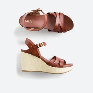 Brown and tan wedge sandals.